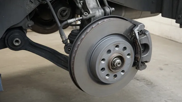 Illustration of a brake caliper, pads, rotor and nearby suspension components at a car wheel
