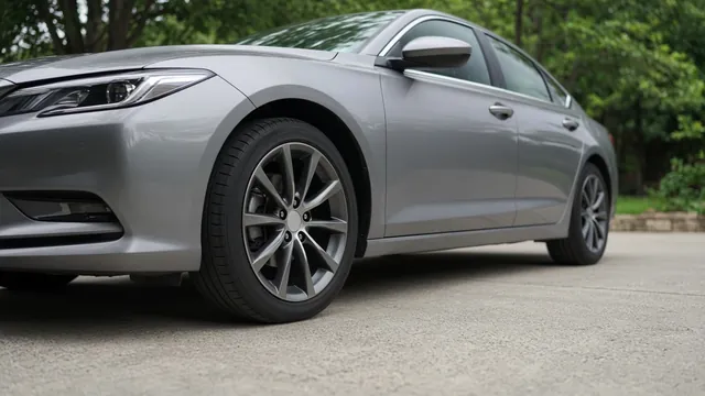 Parked car with its front tire and wheel visible during a ground-level visual inspection