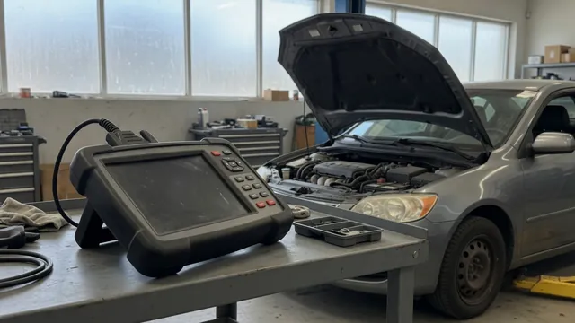 Diagnostic scan tool beside a vehicle with its hood open in an automotive workshop