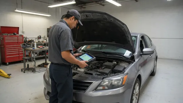 Technician reviewing engine diagnostic data on a scan tool beside an open vehicle hood