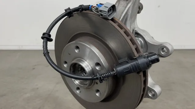 Illustration of a front wheel speed sensor, wiring connector, and hub assembly