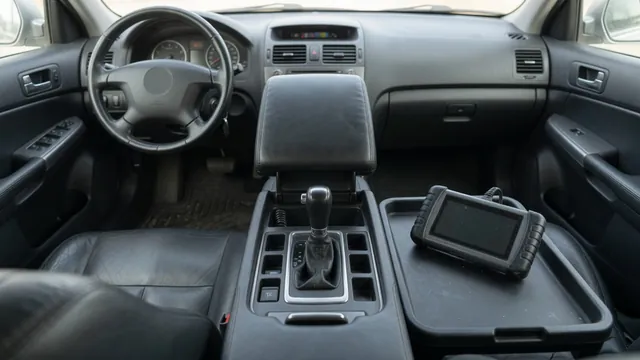 Vehicle gear selector and dashboard gear display with a diagnostic scan tool nearby