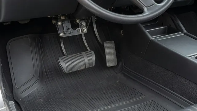 Brake pedal and brake light switch beneath a vehicle dashboard