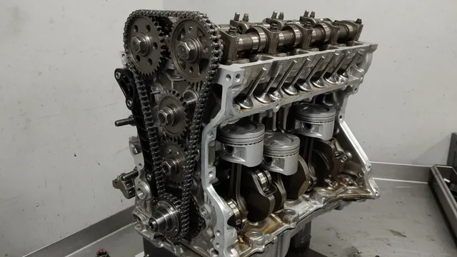 Cutaway illustration of an engine timing chain, camshaft sprockets, pistons, and valves