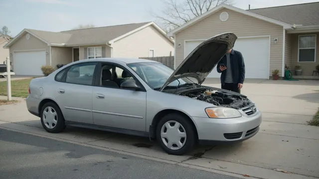 Hyundai sedan parked with its hood open while the driver waits for roadside assistance