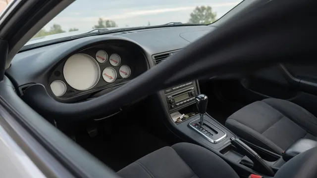Car instrument cluster with tachometer and transmission selector visible