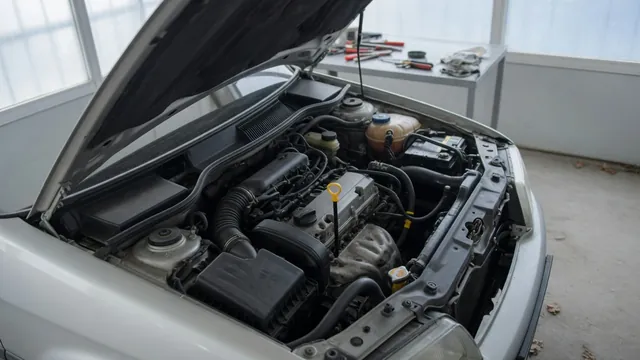 Oil dipstick and oil filler cap in an engine bay during an oil level inspection