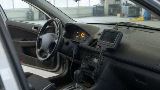 Diagnostic scanner beside a vehicle dashboard with a check engine light illuminated