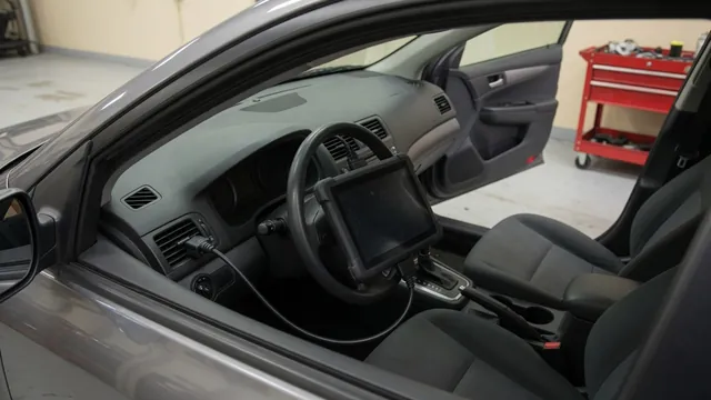 Diagnostic scan tool beside a vehicle dashboard during a trouble code inspection