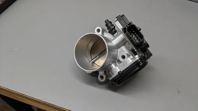 Illustration of an electronic throttle body with its housing, throttle plate, and electrical connector visible