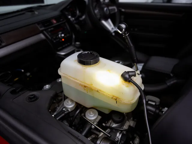 Power steering fluid reservoir inspected for signs of leakage with the engine off