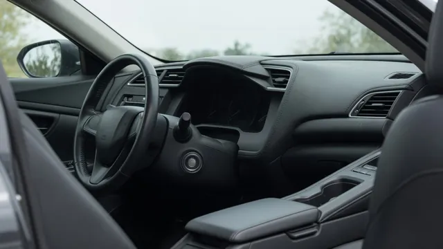Unlit dashboard and ignition button inside a parked car with no electrical response