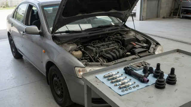 Spark plugs and an ignition coil beside an engine with the ignition switched off