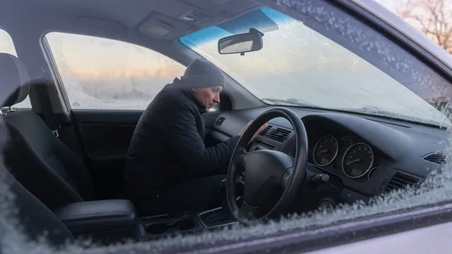 Driver observing the tachometer and warning lights during an outdoor cold start