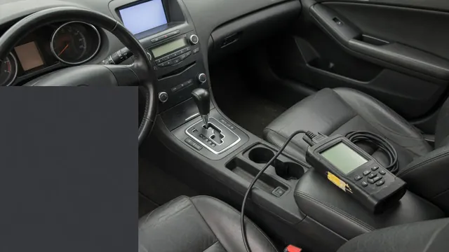 Vehicle gear selector and instrument cluster beside a diagnostic scan tool