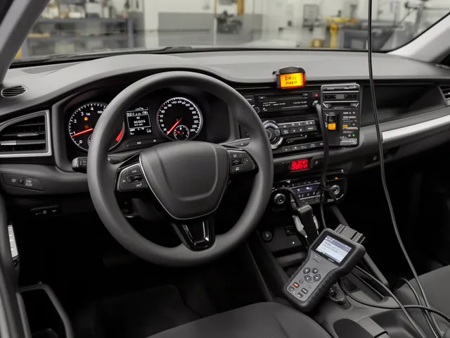 Illuminated ABS warning light on a dashboard with a diagnostic scanner nearby