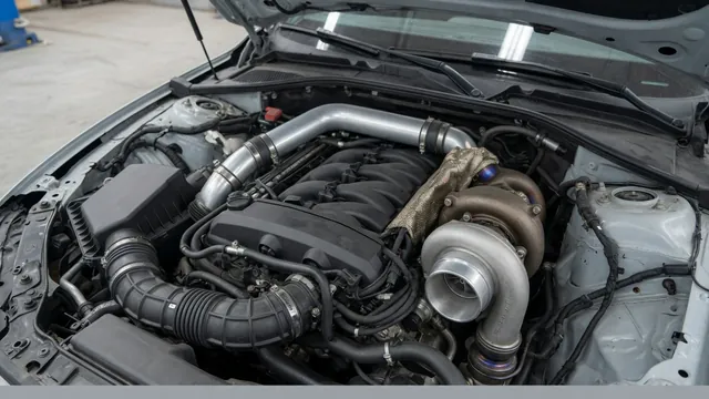 BMW engine bay with turbocharger housing and intake plumbing visible during a workshop inspection