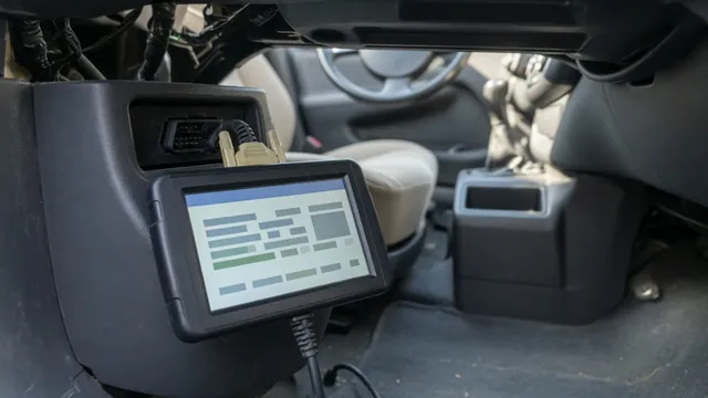 Handheld scan tool connected to a car's OBD-II port and showing body system diagnostic trouble codes