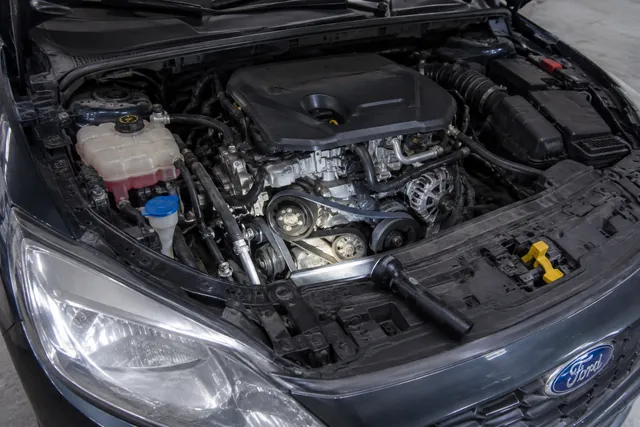 Engine-off inspection of the accessory belt and pulleys in a Ford Focus engine bay