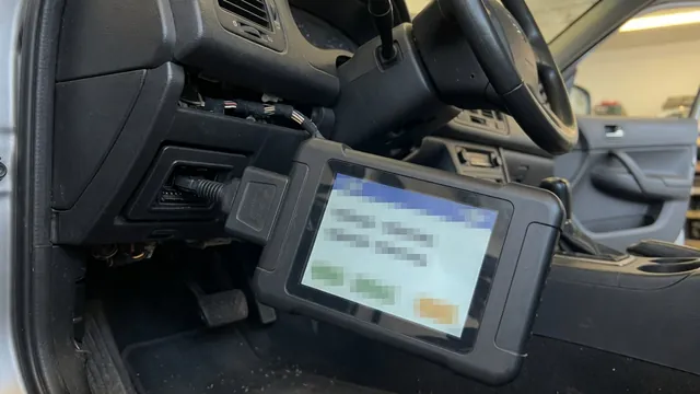 OBD-II scan tool connected under a car dashboard, reading a manufacturer-specific trouble code