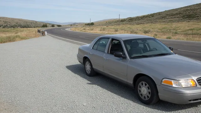 Car safely parked in a roadside turnout with hazard lights on after an engine stall