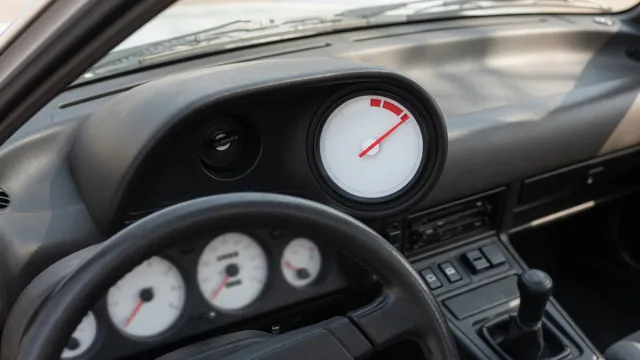 Dashboard temperature gauge showing an elevated reading with the vehicle parked safely