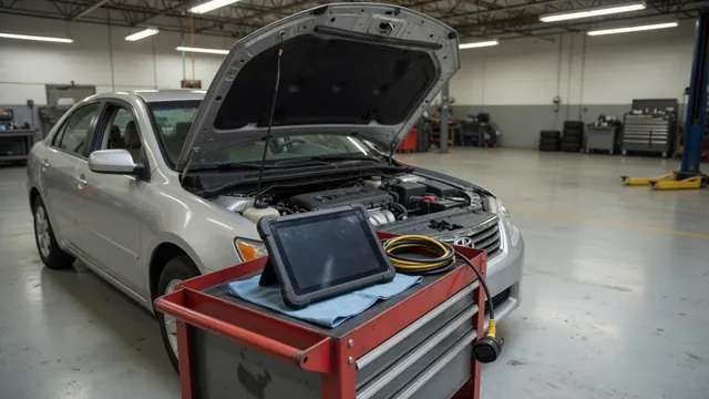 Diagnostic scanner beside a parked vehicle with its hood open