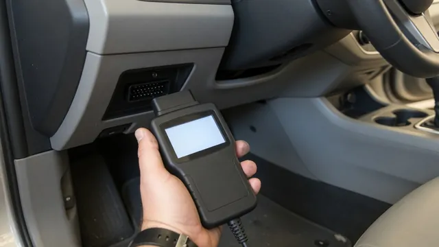 Technician connecting an OBD-II scan tool to a car's diagnostic port to read a manufacturer-specific trouble code