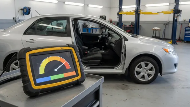 Diagnostic scan tool displaying transmission fluid temperature data beside a vehicle in a service bay.