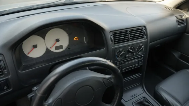 Dashboard showing an engine warning light and tachometer at idle while the vehicle is parked