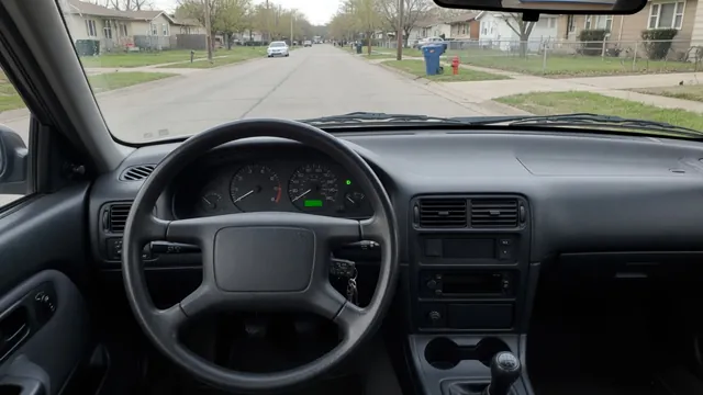 Driver’s view of a stationary car with the gear indicator in Drive and the tachometer at idle
