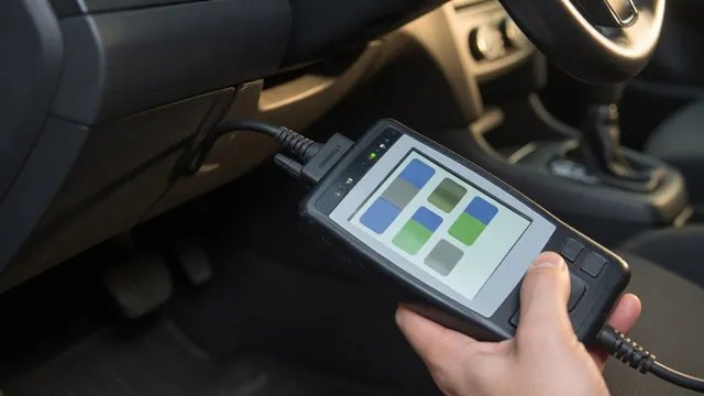 OBD-II scan tool connected under a car dashboard to read a manufacturer-specific trouble code