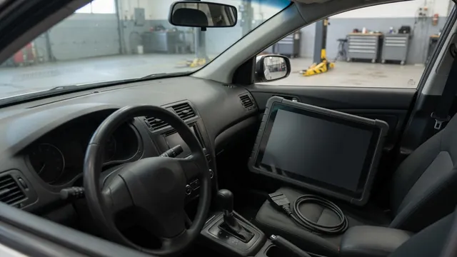 Diagnostic scanner beside a vehicle dashboard during a trouble code inspection
