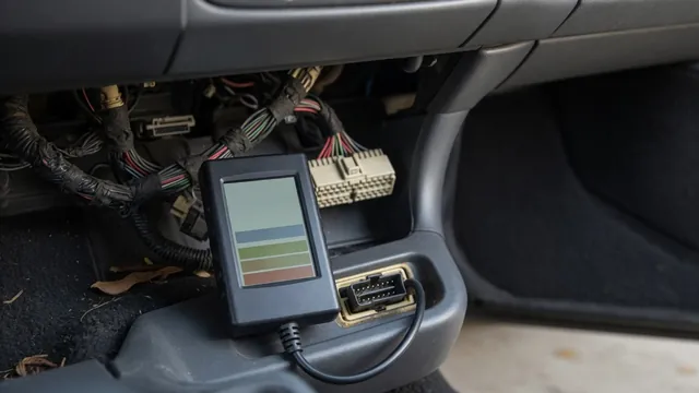 OBD-II scan tool plugged into a car's diagnostic port, showing a network communication fault code