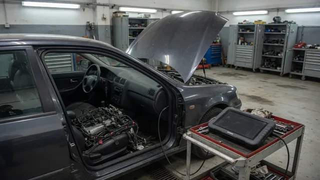 Diagnostic scanner beside a parked vehicle with its engine off and hood open