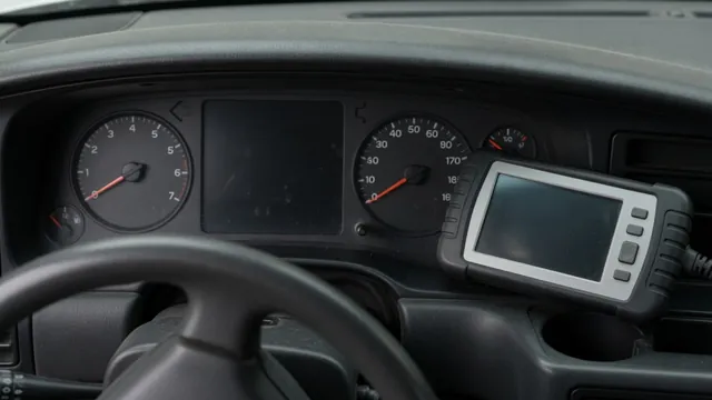 Instrument cluster with dark gauges and a blank information display beside a diagnostic scan tool
