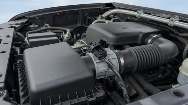 Illustration of a truck intake duct with the mass air flow sensor housing and electrical connector highlighted.