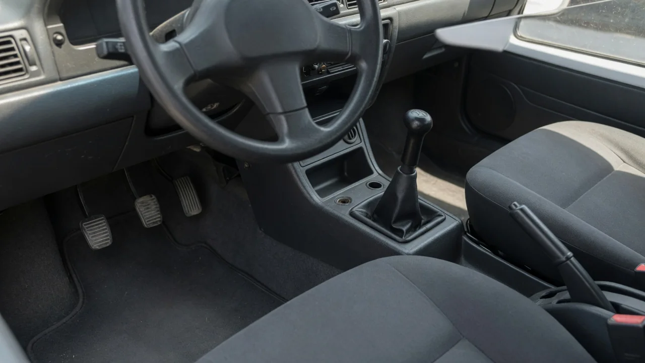 Manual gear shifter and clutch pedal in a Toyota Corolla interior