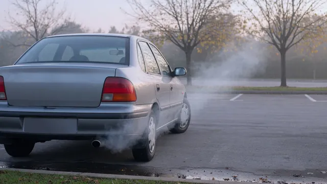 Light vapor drifting from a parked car’s tailpipe outdoors on a cool morning