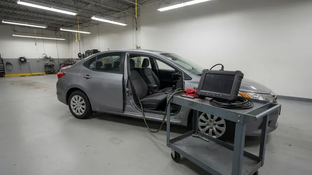 Diagnostic scanner beside a vehicle showing transmission fault codes P2721 through P2725