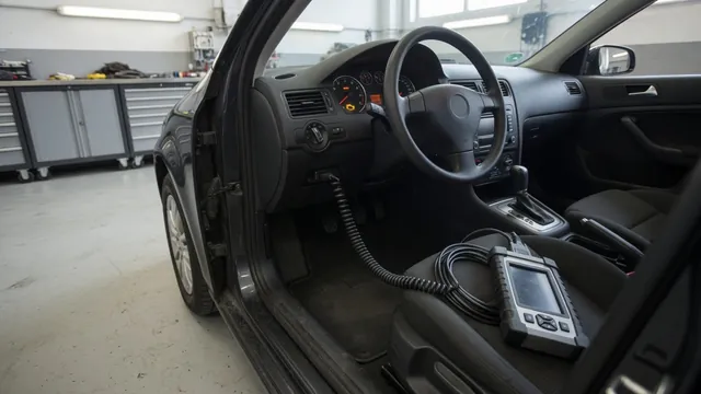 Diagnostic scanner connected beneath a vehicle dashboard with a check engine light illuminated
