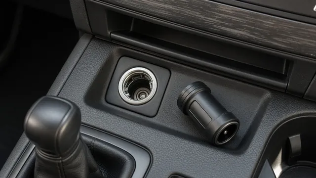 Car center console with an empty 12V socket and an unplugged accessory charger beside it