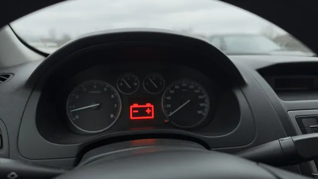 Dashboard battery warning light in a parked car with the ignition on and engine stopped