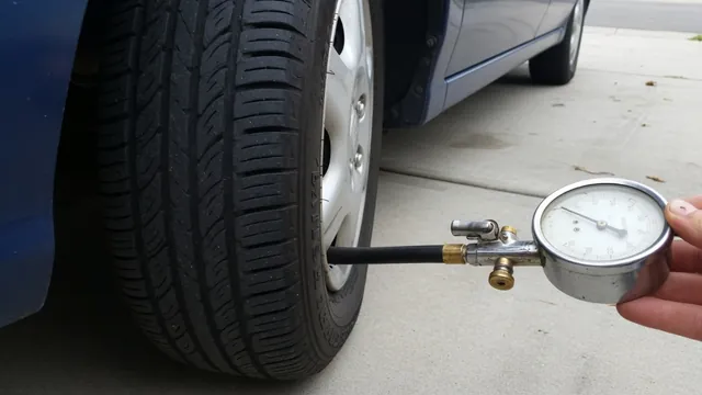 Tire pressure gauge checking a parked vehicle’s tire beside the valve stem