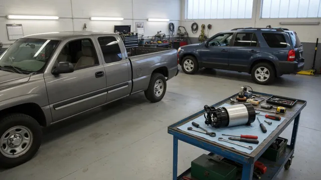 Chevy Silverado and Tahoe parked in a service bay with a fuel pump module on a nearby workbench