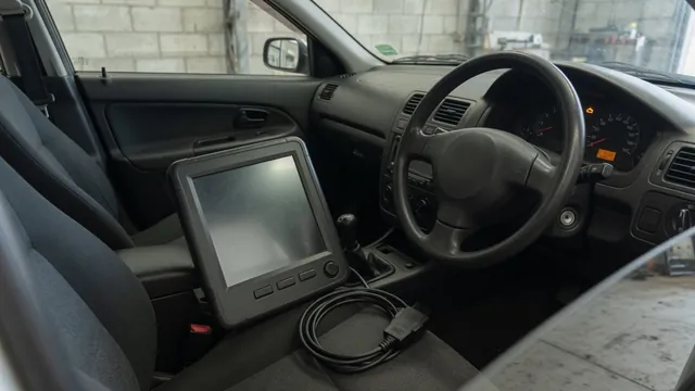 Diagnostic scanner beside a vehicle dashboard with a check engine warning light