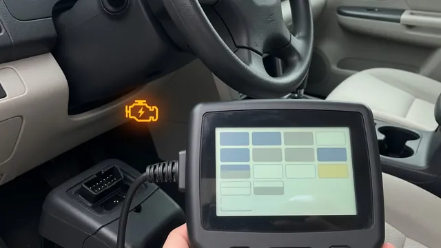 OBD-II scan tool plugged in under a car dashboard while the check engine light is on
