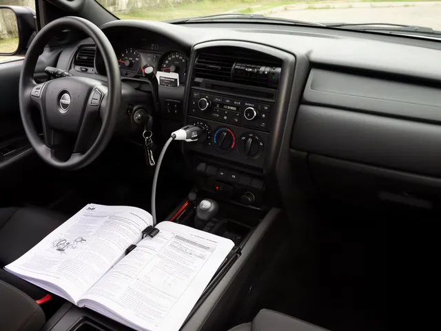 Dashboard ignition controls and fuel gauge beside a parked vehicle's owner's manual
