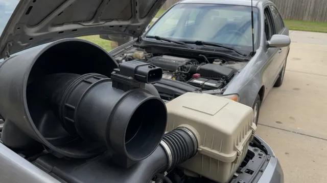 Illustration of an airflow sensor mounted in a Mazda engine intake duct near the air filter housing
