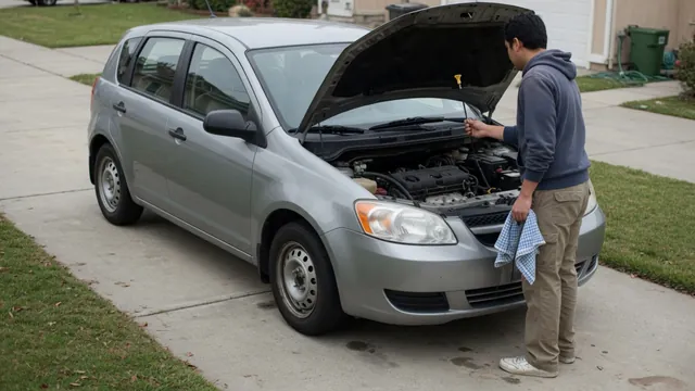 Driver checking an engine oil dipstick with the vehicle parked and engine off